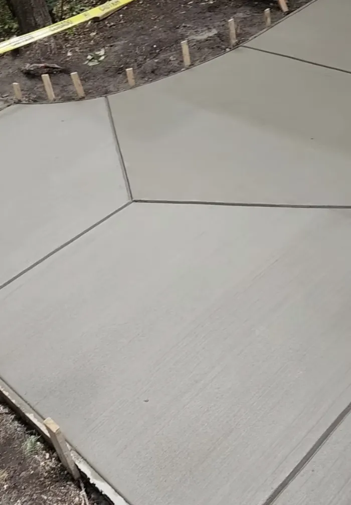 Smooth gray concrete slab with clean control joints and form stakes