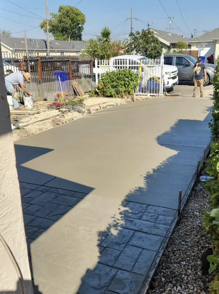 Wet concrete driveway freshly poured and screeded in a residential street